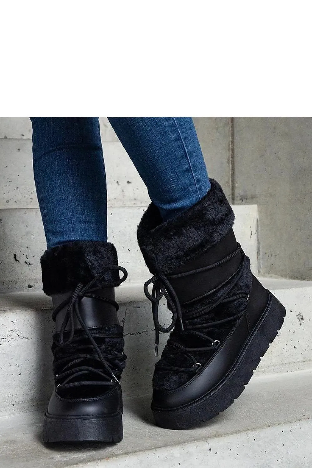 Black lined snow boots laced with fur