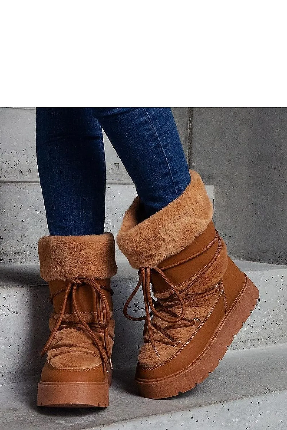 Black lined snow boots laced with fur